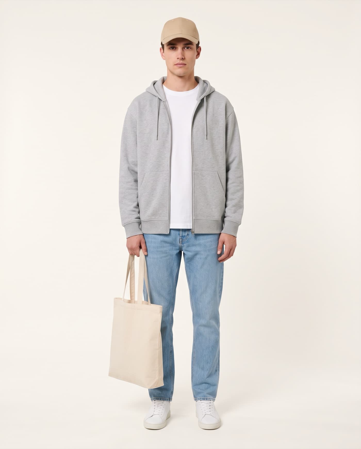 Model wearing a Customanic cap, full-zip hoodie and tee, carrying a canvas tote bag